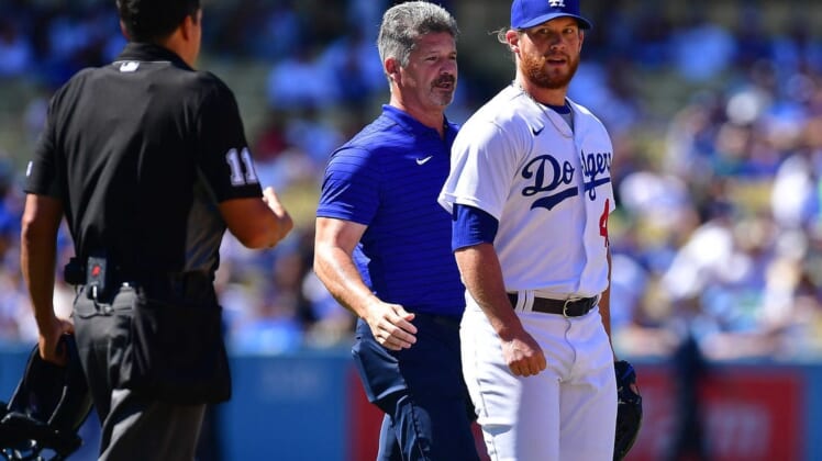 Jul 3, 2022; Los Angeles, California, USA; Los Angeles Dodgers relief pitcher Craig Kimbrel (46) with trainer Nate Lucero after taking a comeback hit by San Diego Padres second baseman Jake Cronenworth (9) during the ninth inning at Dodger Stadium. Mandatory Credit: Gary A. Vasquez-USA TODAY Sports
