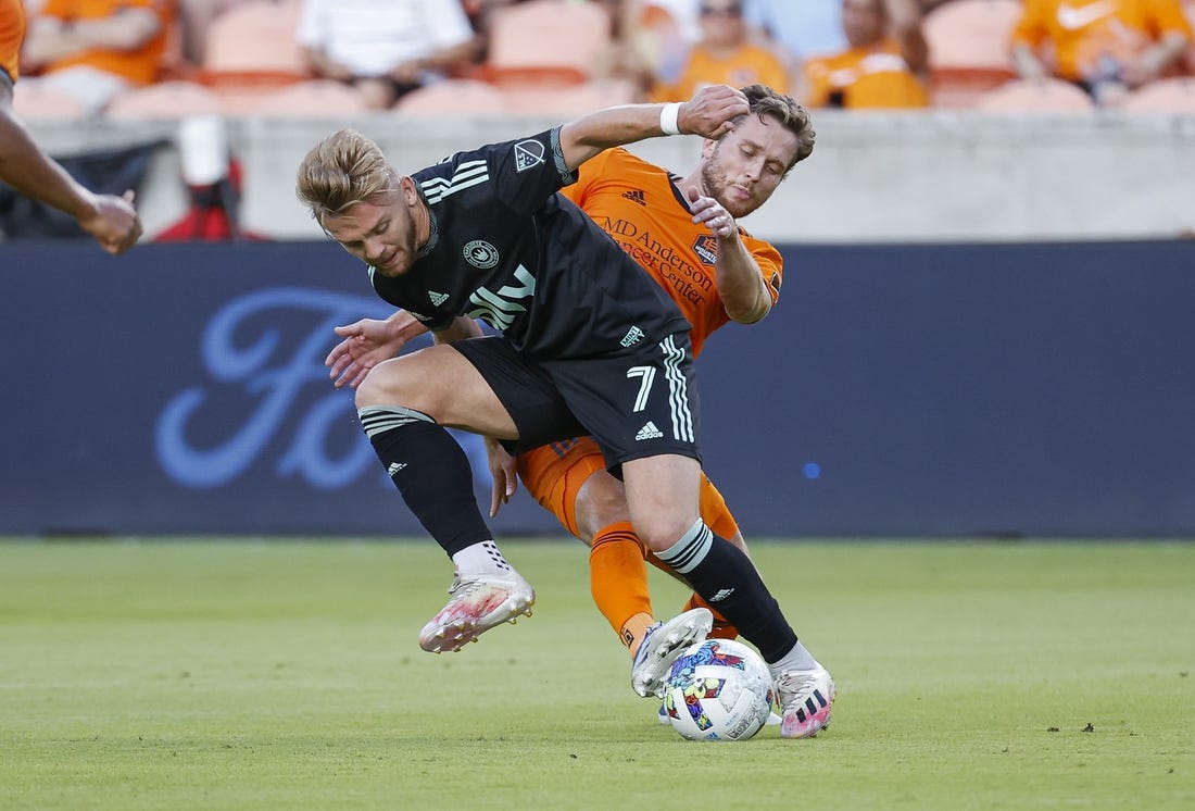 Jul 3, 2022; Houston, Texas, USA; Charlotte FC midfielder Kamil Jozwiak (7) and Houston Dynamo FC defender Adam Lundqvist (3) battle for the ball during the first half at PNC Stadium. Mandatory Credit: Troy Taormina-USA TODAY Sports