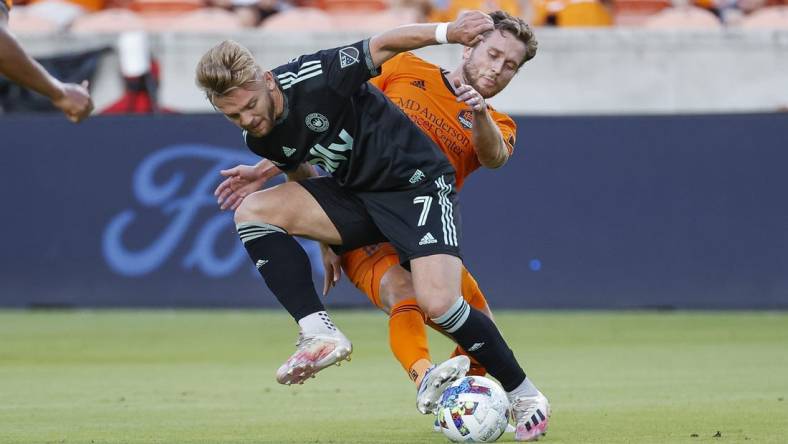 Jul 3, 2022; Houston, Texas, USA; Charlotte FC midfielder Kamil Jozwiak (7) and Houston Dynamo FC defender Adam Lundqvist (3) battle for the ball during the first half at PNC Stadium. Mandatory Credit: Troy Taormina-USA TODAY Sports