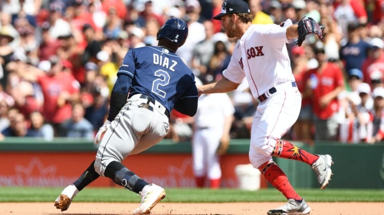 Jul 4, 2022; Boston, Massachusetts, USA; Boston Red Sox pitcher Kutter Crawford (50) tags out Tampa Bay Rays third baseman Yandy Diaz (2) during the fifth inning at Fenway Park. Mandatory Credit: Brian Fluharty-USA TODAY Sports