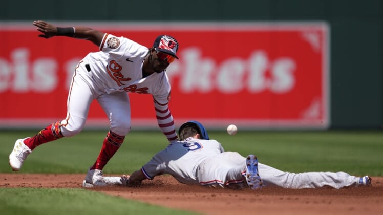 Jul 4, 2022; Baltimore, Maryland, USA; Texas Rangers outfielder Steven Duggar (9) steals second base in the second inning defended by Baltimore Orioles shortstop Jorge Mateo (3) at Oriole Park at Camden Yards. Mandatory Credit: Mitch Stringer-USA TODAY Sports