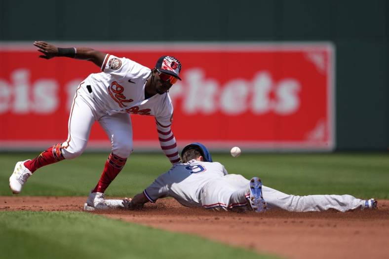 Jul 4, 2022; Baltimore, Maryland, USA; Texas Rangers outfielder Steven Duggar (9) steals second base in the second inning defended by Baltimore Orioles shortstop Jorge Mateo (3) at Oriole Park at Camden Yards. Mandatory Credit: Mitch Stringer-USA TODAY Sports