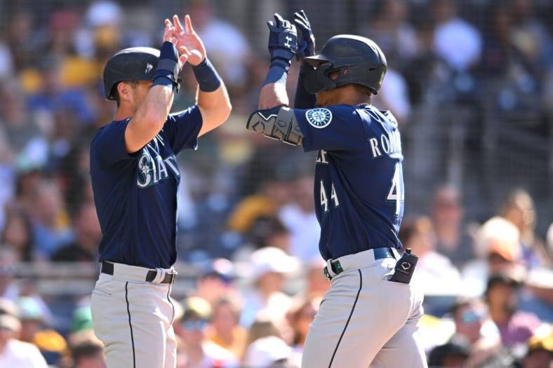 Jul 4, 2022; San Diego, California, USA; Seattle Mariners center fielder Julio Rodriguez (44) celebrates with left fielder Dylan Moore (left) after hitting a two-run home run during the fourth inning against the San Diego Padres at Petco Park. Mandatory Credit: Orlando Ramirez-USA TODAY Sports