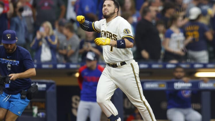 Jul 4, 2022; Milwaukee, Wisconsin, USA;  Milwaukee Brewers catcher Victor Caratini (7) celebrates after hitting a three run home run during the tenth inning against the Chicago Cubs at American Family Field. Mandatory Credit: Jeff Hanisch-USA TODAY Sports