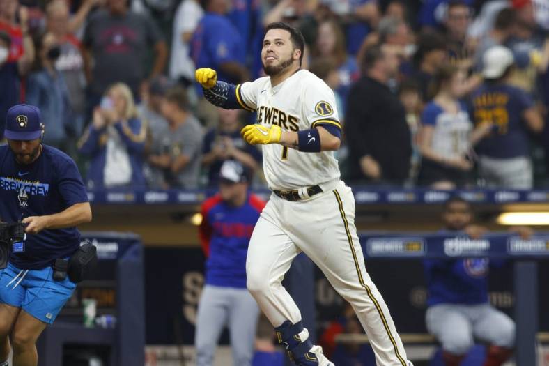 Jul 4, 2022; Milwaukee, Wisconsin, USA;  Milwaukee Brewers catcher Victor Caratini (7) celebrates after hitting a three run home run during the tenth inning against the Chicago Cubs at American Family Field. Mandatory Credit: Jeff Hanisch-USA TODAY Sports
