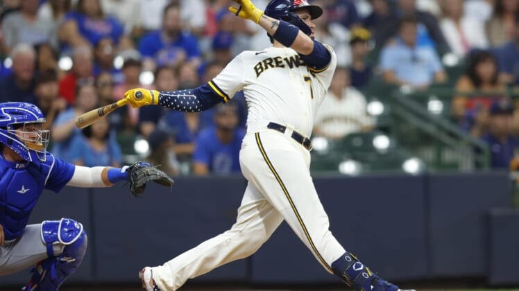 Jul 4, 2022; Milwaukee, Wisconsin, USA;  Milwaukee Brewers catcher Victor Caratini (7) hits a three run home run during the tenth inning against the Chicago Cubs at American Family Field. Mandatory Credit: Jeff Hanisch-USA TODAY Sports
