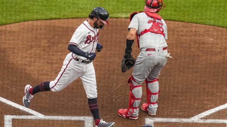 Jul 4, 2022; Cumberland, Georgia, USA; Atlanta Braves shortstop Dansby Swanson (7) scores a run behind St. Louis Cardinals catcher Austin Romine (35) during the first inning at Truist Park. Mandatory Credit: Dale Zanine-USA TODAY Sports