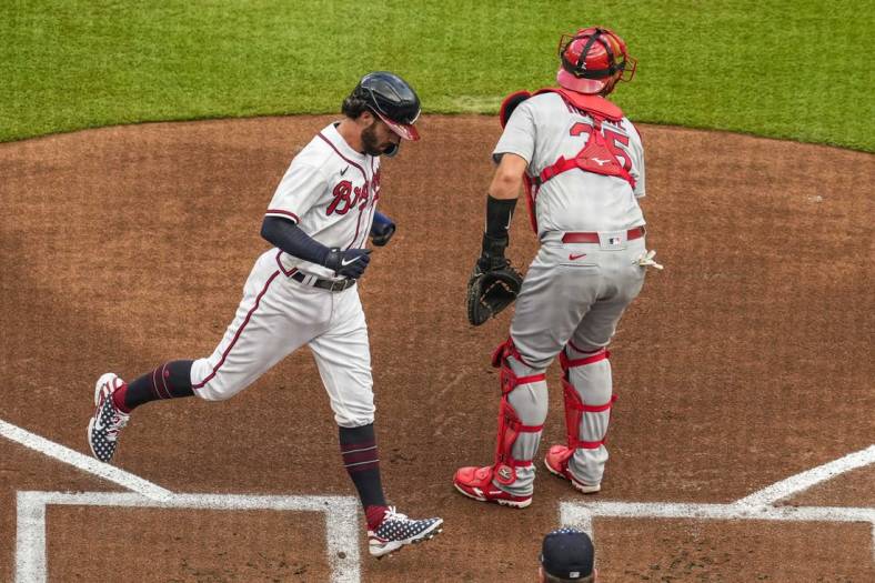 Jul 4, 2022; Cumberland, Georgia, USA; Atlanta Braves shortstop Dansby Swanson (7) scores a run behind St. Louis Cardinals catcher Austin Romine (35) during the first inning at Truist Park. Mandatory Credit: Dale Zanine-USA TODAY Sports