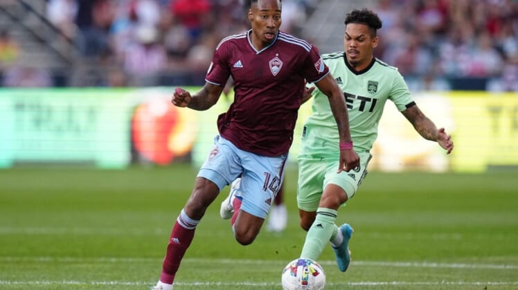 Jul 4, 2022; Commerce City, Colorado, USA; Colorado Rapids midfielder Mark-Anthony Kaye (14) drives past Austin FC midfielder Daniel Pereira (6) in the first half at Dick's Sporting Goods Park. Mandatory Credit: Ron Chenoy-USA TODAY Sports
