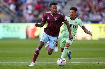 Jul 4, 2022; Commerce City, Colorado, USA; Colorado Rapids midfielder Mark-Anthony Kaye (14) drives past Austin FC midfielder Daniel Pereira (6) in the first half at Dick's Sporting Goods Park. Mandatory Credit: Ron Chenoy-USA TODAY Sports