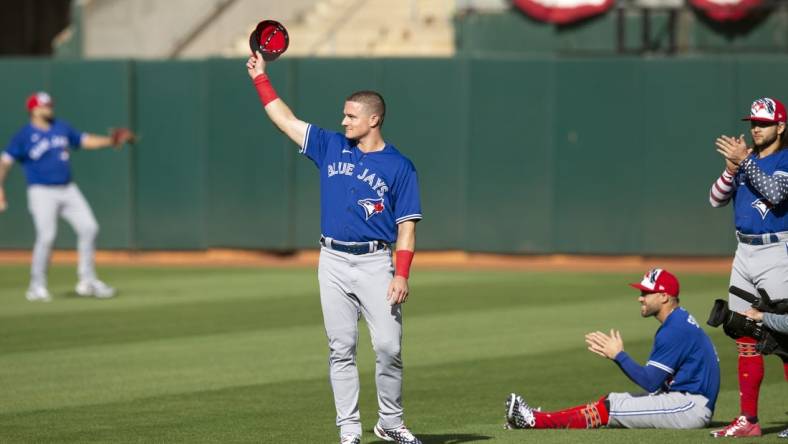 Jul 4, 2022; Oakland, California, USA; Toronto Blue Jays third baseman Matt Chapman (26) acknowledges the cheers of fans of his former team, the Oakland Athletics, before a game at RingCentral Coliseum. Mandatory Credit: D. Ross Cameron-USA TODAY Sports