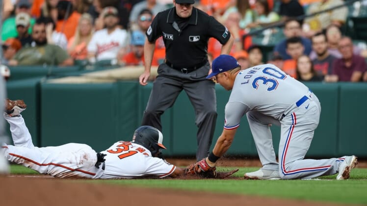 Jul 5, 2022; Baltimore, Maryland, USA; Baltimore Orioles center fielder Cedric Mullins (31) is tagged out by Texas Rangers first baseman Nathaniel Lowe (30) during the first inning at Oriole Park at Camden Yards. Mandatory Credit: Scott Taetsch-USA TODAY Sports
