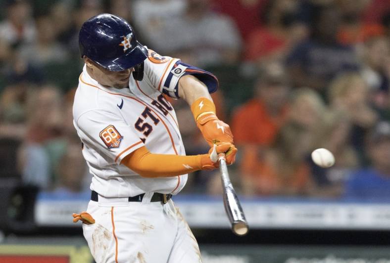 Jul 5, 2022; Houston, Texas, USA;  Houston Astros first baseman Aledmys Diaz (16) hits a single against the Kansas City Royals in the second inning at Minute Maid Park. Mandatory Credit: Thomas Shea-USA TODAY Sports