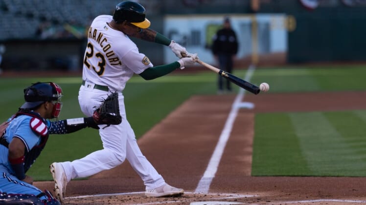 Jul 5, 2022; Oakland, California, USA; Oakland Athletics first baseman Christian Bethancourt (23) hits a RBI single during the first inning against the Toronto Blue Jays at RingCentral Coliseum. Mandatory Credit: Stan Szeto-USA TODAY Sports