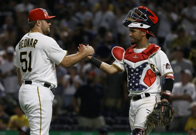Jul 5, 2022; Pittsburgh, Pennsylvania, USA; Pittsburgh Pirates relief pitcher David Bednar (51) and catcher Michael Perez (5) celebrate after defeating the New York Yankees at PNC Park. The Pirates won 5-2. Mandatory Credit: Charles LeClaire-USA TODAY Sports