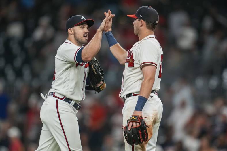 Jul 5, 2022; Cumberland, Georgia, USA; Atlanta Braves left fielder Adam Duvall (14) and third baseman Austin Riley (27) react after the Braves defeated the St. Louis Cardinals at Truist Park. Mandatory Credit: Dale Zanine-USA TODAY Sports
