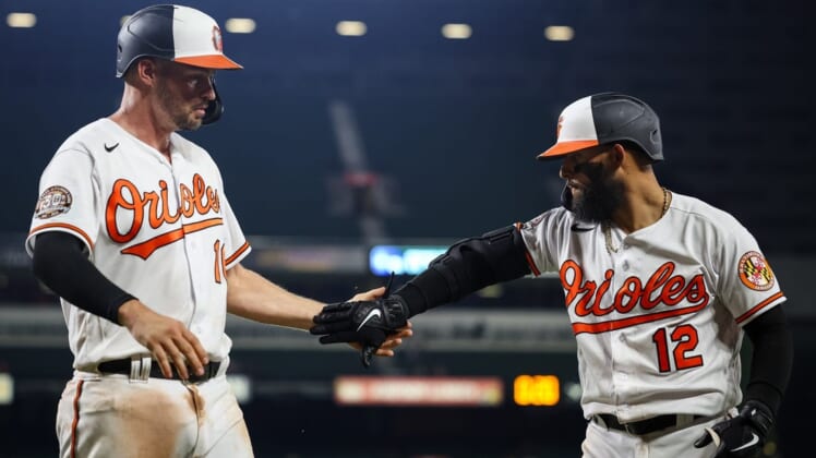 Jul 5, 2022; Baltimore, Maryland, USA; Baltimore Orioles first baseman Trey Mancini (16) celebrates with second baseman Rougned Odor (12) after scoring against the Texas Rangers during the seventh inning at Oriole Park at Camden Yards. Mandatory Credit: Scott Taetsch-USA TODAY Sports