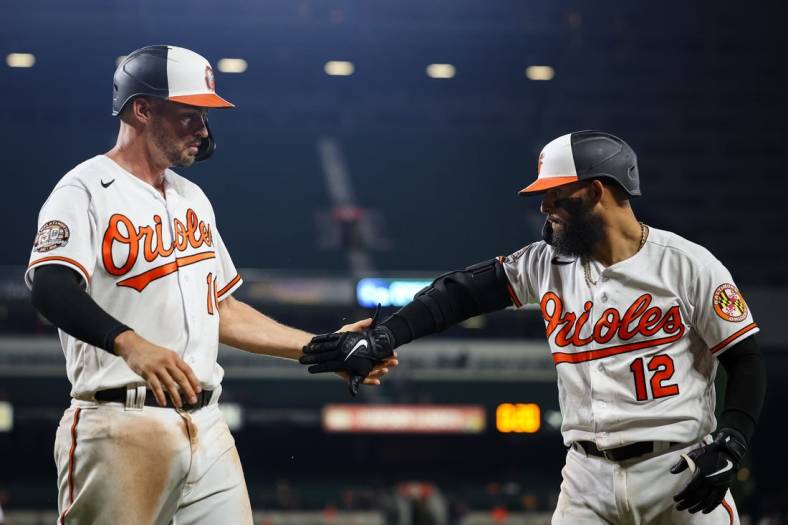 Jul 5, 2022; Baltimore, Maryland, USA; Baltimore Orioles first baseman Trey Mancini (16) celebrates with second baseman Rougned Odor (12) after scoring against the Texas Rangers during the seventh inning at Oriole Park at Camden Yards. Mandatory Credit: Scott Taetsch-USA TODAY Sports