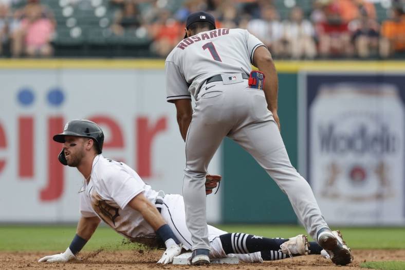 Jul 6, 2022; Detroit, Michigan, USA; Detroit Tigers third baseman Kody Clemens (21) slides safely at second under the tag by Cleveland Guardians shortstop Amed Rosario (1) during second inning at Comerica Park. Mandatory Credit: Rick Osentoski-USA TODAY Sports