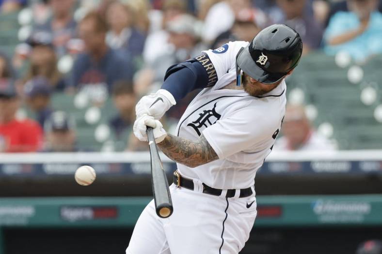 Jul 6, 2022; Detroit, Michigan, USA; Detroit Tigers catcher Tucker Barnhart (15) hits an RBI single during the second inning against the Cleveland Guardians at Comerica Park. Mandatory Credit: Rick Osentoski-USA TODAY Sports