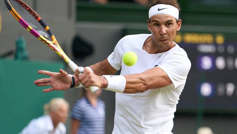 Jul 6, 2022; London, England, United Kingdom; 
Rafael Nadal (ESP) returns a shot during his quarter finals men   s singles match against Taylor Fritz (USA) on Centre court at All England Lawn Tennis and Croquet Club. Mandatory Credit: Peter van den Berg-USA TODAY Sports