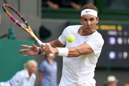 Jul 6, 2022; London, England, United Kingdom; 
Rafael Nadal (ESP) returns a shot during his quarter finals men   s singles match against Taylor Fritz (USA) on Centre court at All England Lawn Tennis and Croquet Club. Mandatory Credit: Peter van den Berg-USA TODAY Sports