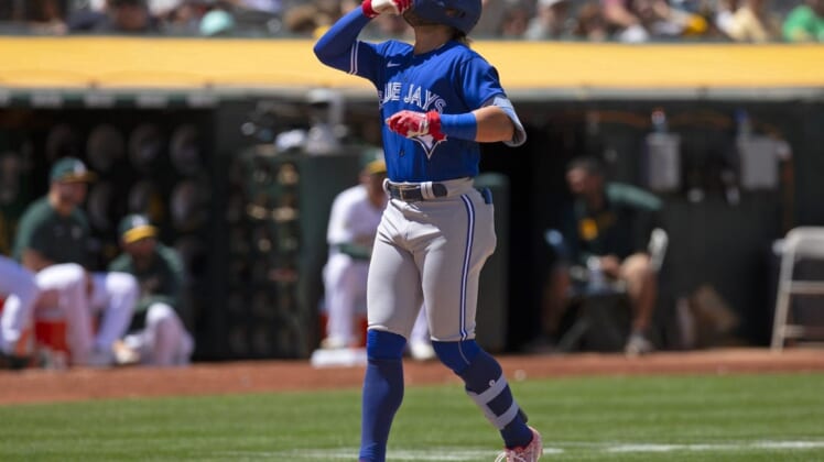 Jul 6, 2022; Oakland, California, USA; Toronto Blue Jays shortstop Bo Bichette (11) celebrates after hitting a solo home run against the Oakland Athletics during the eighth inning at RingCentral Coliseum. Mandatory Credit: D. Ross Cameron-USA TODAY Sports