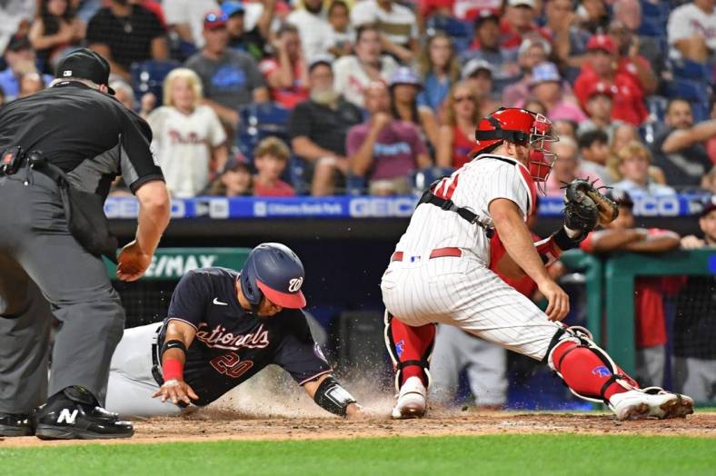 Jul 6, 2022; Philadelphia, Pennsylvania, USA; Washington Nationals catcher Keibert Ruiz (20) slides safely into home plate ahead of tag by Philadelphia Phillies catcher J.T. Realmuto (10) during the seventh inning at Citizens Bank Park. Mandatory Credit: Eric Hartline-USA TODAY Sports