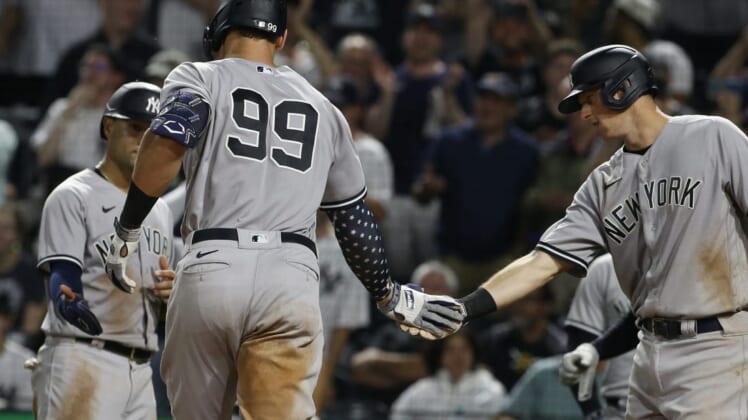 Jul 6, 2022; Pittsburgh, Pennsylvania, USA; New York Yankees shortstop Isiah Kiner-Falefa (left) and first  baseman DJ LeMahieu (right) congratulate center fielder Aaron Judge (99) after hitting a grand slam home run against the Pittsburgh Pirates during the eighth inning at PNC Park. Mandatory Credit: Charles LeClaire-USA TODAY Sports
