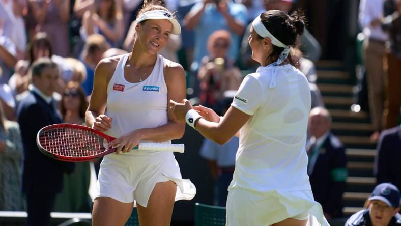 Jul 7, 2022; London, England, United Kingdom;  
Ons Jabeur (TUN), pictured right, celebrates at the net after her semi finals women s singles match against Tatjana Maria (GER) who is a close friend on Centre court at All England Lawn Tennis and Croquet Club. Mandatory Credit: Peter van den Berg-USA TODAY Sports