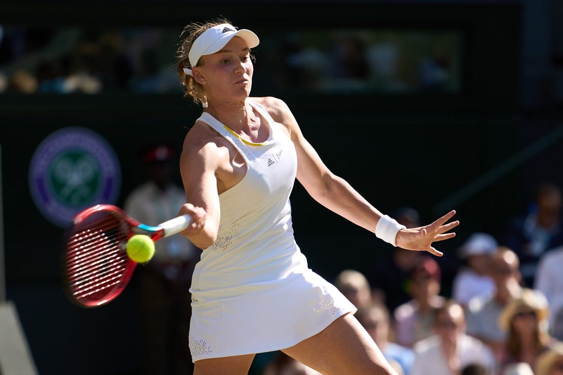 Jul 7, 2022; London, England, United Kingdom;  
Elena Rybakina (KAZ) returns a shot during her semi-finals women   s singles match against Simona Halep (ROU) on Centre court at All England Lawn Tennis and Croquet Club. Mandatory Credit: Peter van den Berg-USA TODAY Sports