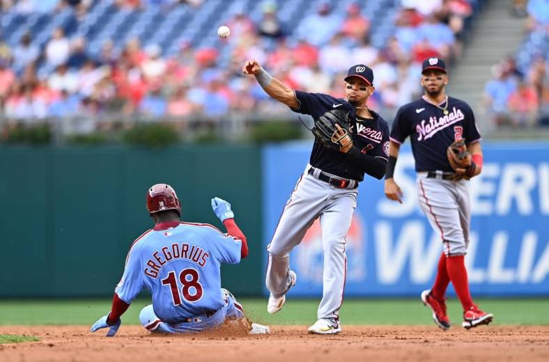 Jul 7, 2022; Philadelphia, Pennsylvania, USA; Washington Nationals second baseman Cesar Hernandez (1) attempts to turn a double play over Philadelphia Phillies shortstop Didi Gregorius (18) in the second inning at Citizens Bank Park. Mandatory Credit: Kyle Ross-USA TODAY Sports