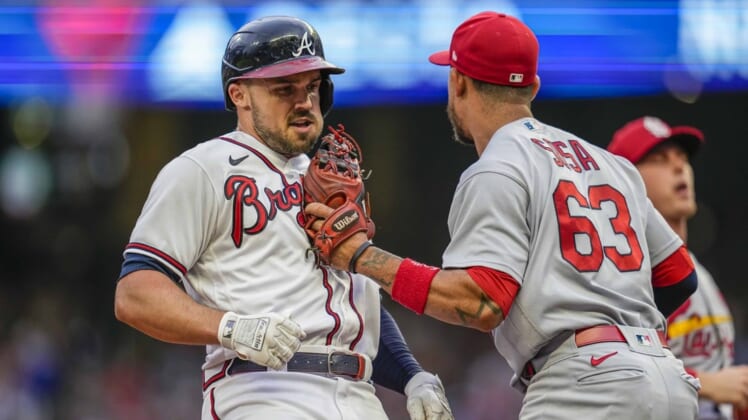 Jul 7, 2022; Cumberland, Georgia, USA; Atlanta Braves left fielder Adam Duvall (14) is tagged out in a run down by St. Louis Cardinals shortstop Edmundo Sosa (63) during the second inning at Truist Park. Mandatory Credit: Dale Zanine-USA TODAY Sports