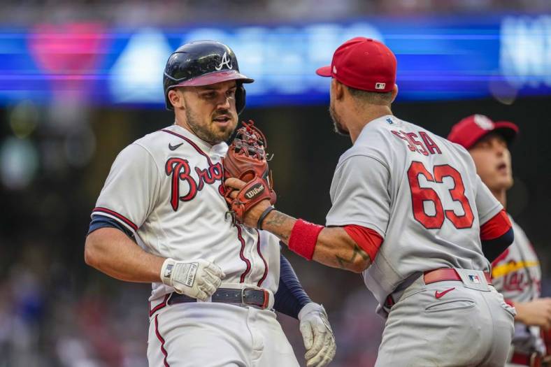 Jul 7, 2022; Cumberland, Georgia, USA; Atlanta Braves left fielder Adam Duvall (14) is tagged out in a run down by St. Louis Cardinals shortstop Edmundo Sosa (63) during the second inning at Truist Park. Mandatory Credit: Dale Zanine-USA TODAY Sports
