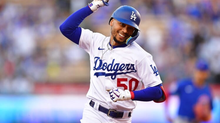 Jul 7, 2022; Los Angeles, California, USA; Los Angeles Dodgers right fielder Mookie Betts (50) runs the bases after hitting a solo home run against the Chicago Cubs during the first inning at Dodger Stadium. Mandatory Credit: Gary A. Vasquez-USA TODAY Sports