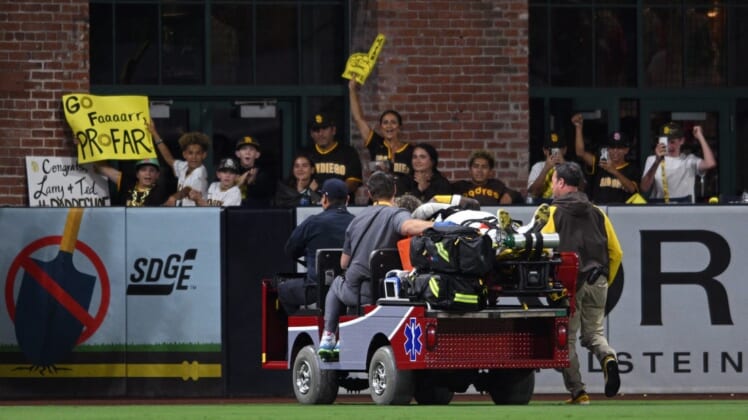 Jul 7, 2022; San Diego, California, USA; San Diego Padres left fielder Jurickson Profar (10) is carted away after a collision with shortstop C.J. Abrams (not pictured) during the fifth inning against the San Francisco Giants at Petco Park. Mandatory Credit: Orlando Ramirez-USA TODAY Sports