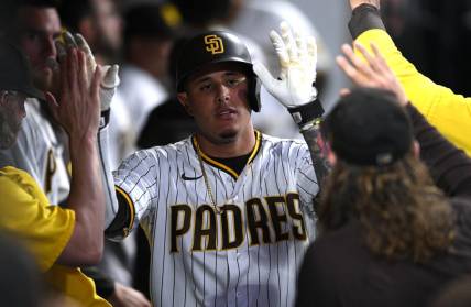 Jul 7, 2022; San Diego, California, USA; San Diego Padres third baseman Manny Machado (13) is congratulated in the dugout after hitting a home run against the San Francisco Giants during the fifth inning at Petco Park. Mandatory Credit: Orlando Ramirez-USA TODAY Sports