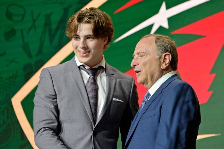 Jul 7, 2022; Montreal, Quebec, CANADA; Liam Ohgren shakes hands with NHL commissioner Gary Bettman after being selected as the number nineteen overall pick to the Minnesota Wild in the first round of the 2022 NHL Draft at Bell Centre. Mandatory Credit: Eric Bolte-USA TODAY Sports
