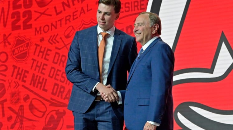 Jul 7, 2022; Montreal, Quebec, CANADA; Simon Nemec shakes hands with NHL commissioner Gary Bettman after being selected as the number two overall pick to the New Jersey Devils in the first round of the 2022 NHL Draft at Bell Centre. Mandatory Credit: Eric Bolte-USA TODAY Sports