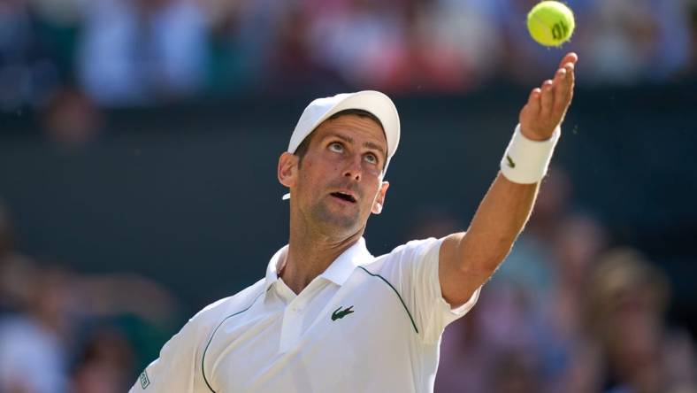 Jul 8, 2022; London, England, United Kingdom;  
Novak Djokovic (SRB) serves during his semi finals men s singles match against Cameron Norrie (GBR) on Centre court at All England Lawn Tennis and Croquet Club. Mandatory Credit: Peter van den Berg-USA TODAY Sports