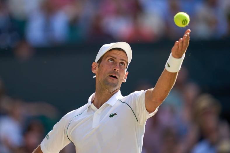Jul 8, 2022; London, England, United Kingdom;  
Novak Djokovic (SRB) serves during his semi finals men s singles match against Cameron Norrie (GBR) on Centre court at All England Lawn Tennis and Croquet Club. Mandatory Credit: Peter van den Berg-USA TODAY Sports