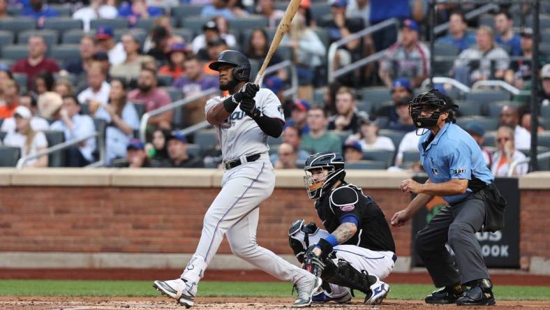 Jul 8, 2022; New York City, New York, USA; Miami Marlins left fielder Bryan De La Cruz (14) hits an RBI double during the second inning against the New York Mets at Citi Field. Mandatory Credit: Vincent Carchietta-USA TODAY Sports