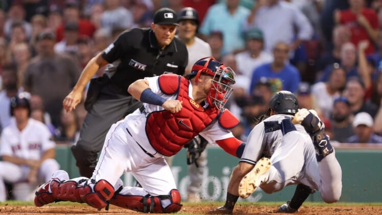 Jul 8, 2022; Boston, Massachusetts, USA; New York Yankees right fielder Joey Gallo (13) is tagged out at home by Boston Red Sox catcher Christian Vazquez (7) during the third inning at Fenway Park. Mandatory Credit: Paul Rutherford-USA TODAY Sports
