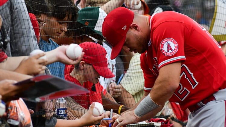 Jul 8, 2022; Baltimore, Maryland, USA;  Los Angeles Angels center fielder Mike Trout (27) sings autographs before the game against the Baltimore Orioles at Oriole Park at Camden Yards. Mandatory Credit: Tommy Gilligan-USA TODAY Sports