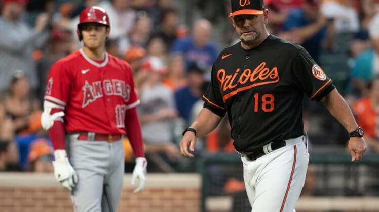 Jul 8, 2022; Baltimore, Maryland, USA;  Baltimore Orioles manager Brandon Hyde (18) walks off the field before Los Angeles Angels center fielder Mike Trout (27) third inning at bat at Oriole Park at Camden Yards. Mandatory Credit: Tommy Gilligan-USA TODAY Sports