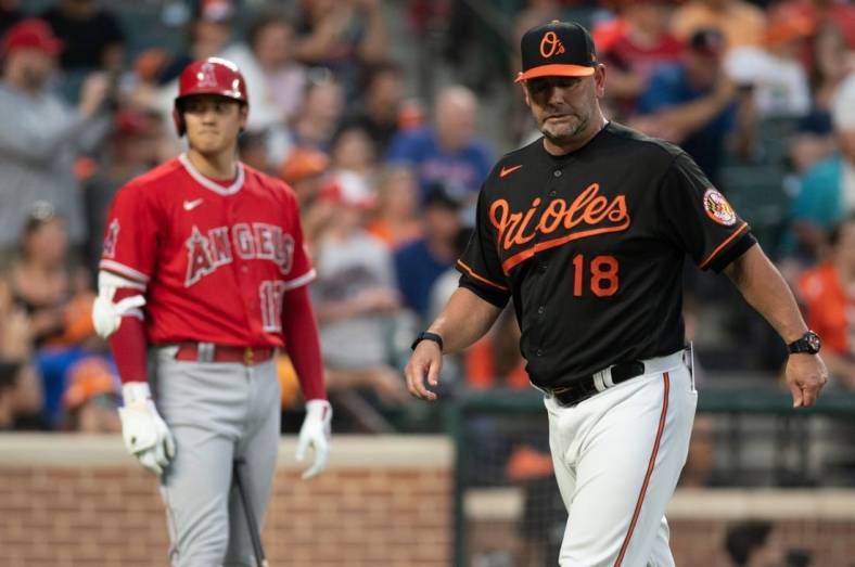 Jul 8, 2022; Baltimore, Maryland, USA;  Baltimore Orioles manager Brandon Hyde (18) walks off the field before Los Angeles Angels center fielder Mike Trout (27) third inning at bat at Oriole Park at Camden Yards. Mandatory Credit: Tommy Gilligan-USA TODAY Sports