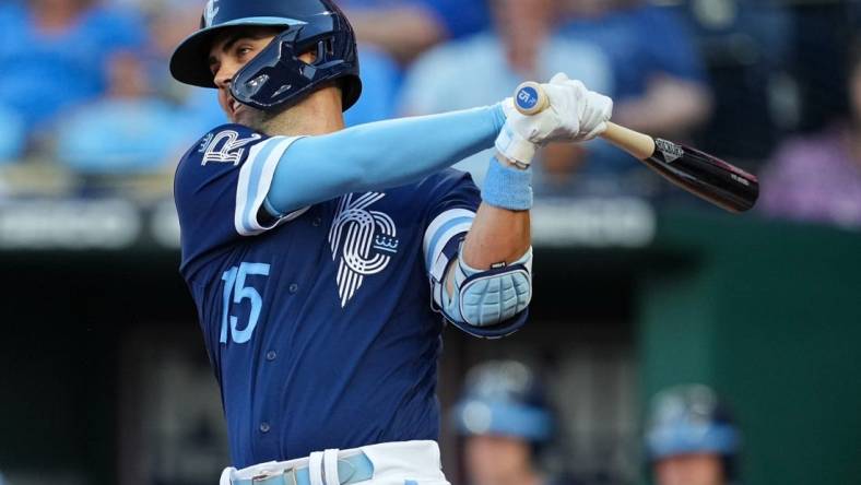 Jul 8, 2022; Kansas City, Missouri, USA; Kansas City Royals second baseman Whit Merrifield (15) hits a single against the Cleveland Guardians during the third inning at Kauffman Stadium. Mandatory Credit: Jay Biggerstaff-USA TODAY Sports