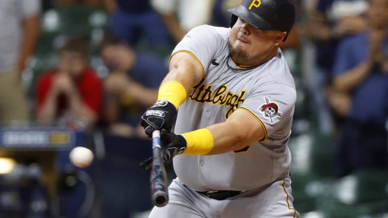 Jul 8, 2022; Milwaukee, Wisconsin, USA;  Pittsburgh Pirates first baseman Daniel Vogelbach (19) hits an RBI single during the ninth inning against the Milwaukee Brewers at American Family Field. Mandatory Credit: Jeff Hanisch-USA TODAY Sports