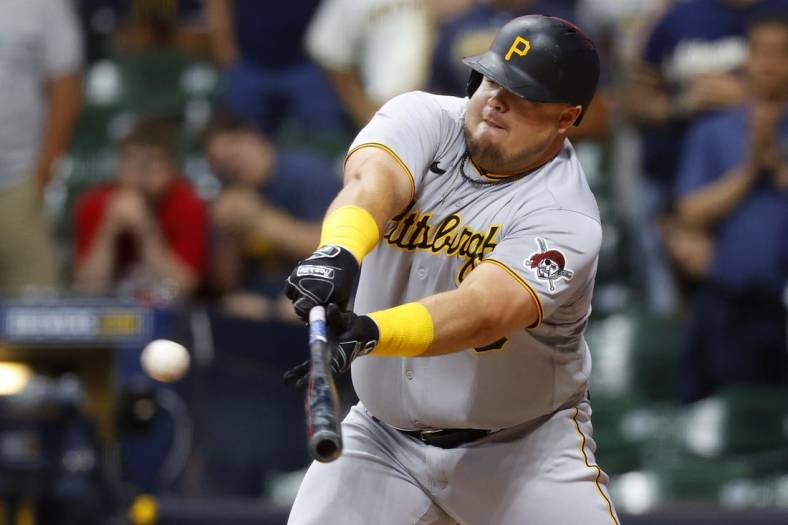 Jul 8, 2022; Milwaukee, Wisconsin, USA;  Pittsburgh Pirates first baseman Daniel Vogelbach (19) hits an RBI single during the ninth inning against the Milwaukee Brewers at American Family Field. Mandatory Credit: Jeff Hanisch-USA TODAY Sports