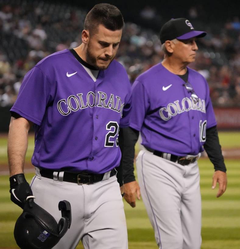 Jul 8, 2022; Phoenix, Arizona, USA; Colorado Rockies first baseman C.J. Cron (25) leaves the game alongside manager Bud Black (10) after being hit by a pitch against the Arizona Diamondbacks during the fifth inning at Chase Field. Mandatory Credit: Joe Camporeale-USA TODAY Sports